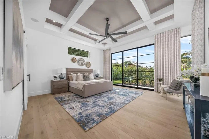 Bedroom featuring light wood-style floors, access to outside, coffered ceiling, beamed ceiling, and baseboards