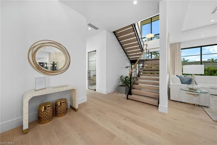 Stairs featuring baseboards, wood finished floors, visible vents, and recessed lighting