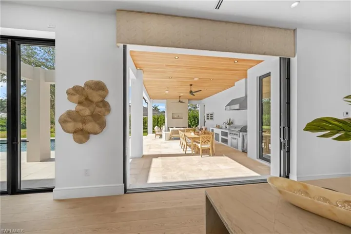 Doorway to outside with light wood-type flooring, baseboards, and recessed lighting