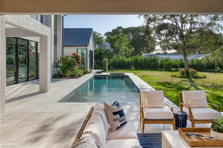 View of pool featuring a fenced in pool, a yard, outdoor lounge area, a patio area, and fence