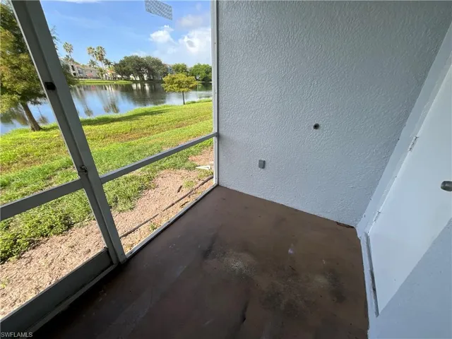 Unfurnished sunroom featuring a water view