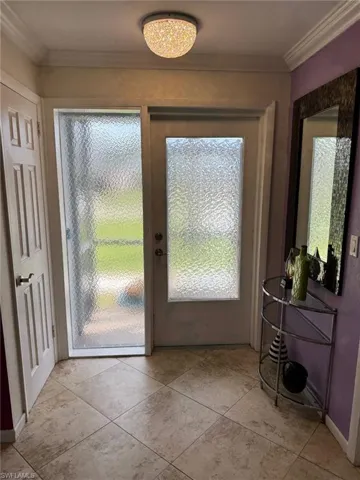 Front entry with coat closet, crown moldings and room for entry table and mirror.
