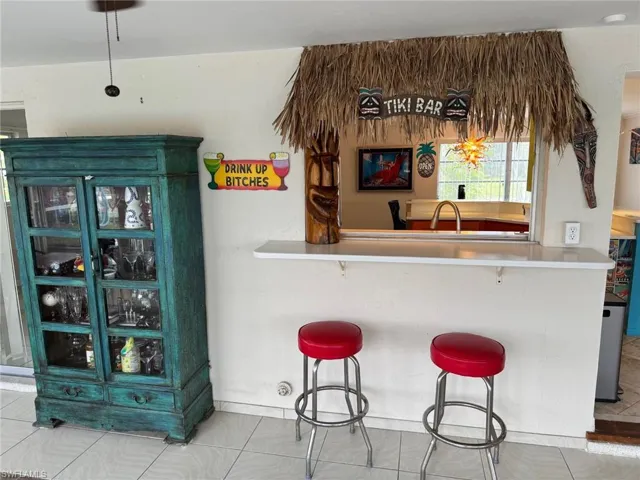The pass through is a tiki bar in the sun room.