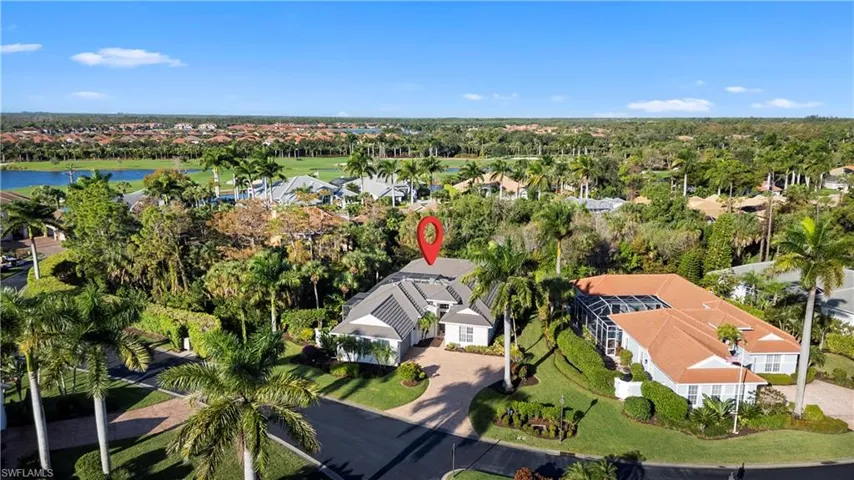Aerial view of property and surrounding area with nearby suburban area and a large body of water