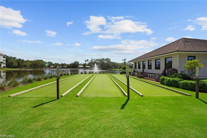 View of home's community featuring a water view and a yard
