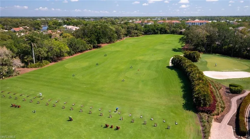 Aerial view of a tree filled landscape and a local golf course