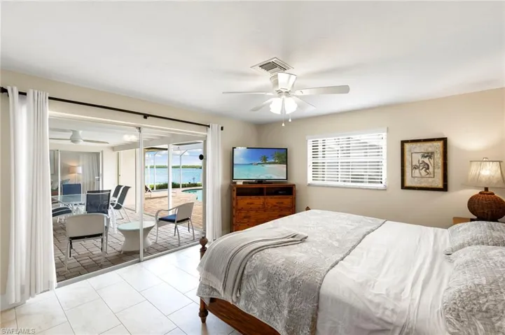 Bedroom featuring ceiling fan and access to exterior