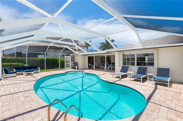 View of pool with a lanai and a patio