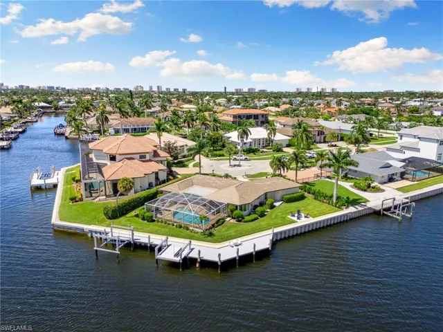 Birds eye view of property with a water view