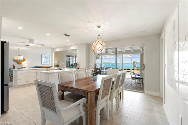 Dining space featuring sink and light tile patterned floors