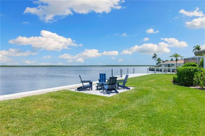 Dock area with a yard and a water view