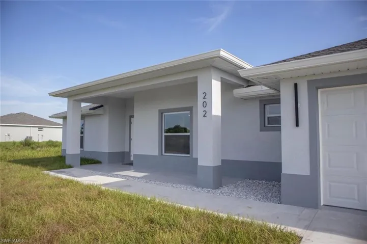 Property entrance with stucco siding and a garage