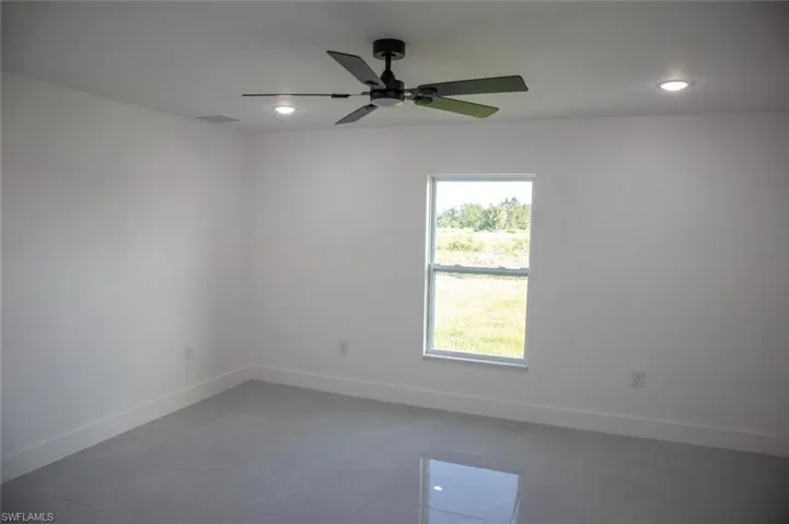 Spare room featuring recessed lighting, ceiling fan, and tile patterned flooring