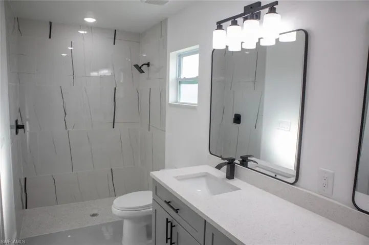 Bathroom with vanity and a stall shower
