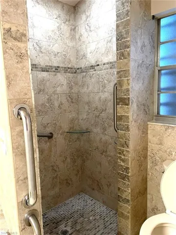 Bathroom featuring plenty of natural light and walk in shower