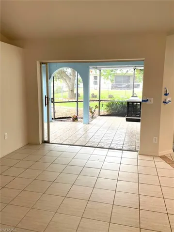 Unfurnished room featuring light tile patterned floors and a wealth of natural light