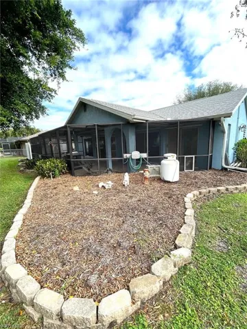 Back of house with a sunroom