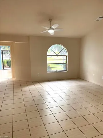 Tiled spare room with ceiling fan