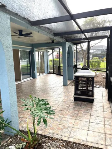 View of patio / terrace featuring ceiling fan and a lanai
