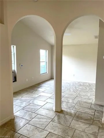 Spare room featuring lofted ceiling