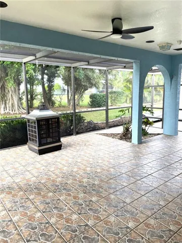 View of patio featuring ceiling fan and glass enclosure