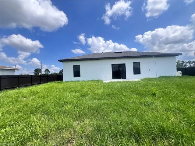 Rear view of house with stucco siding