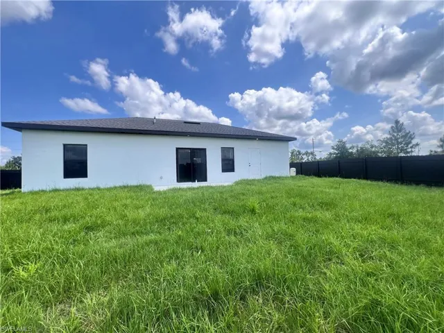 Rear view of property with stucco siding