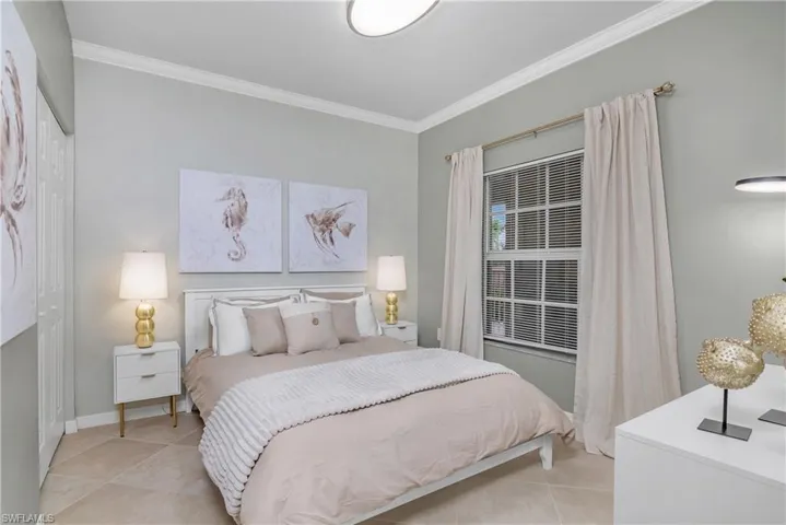 Bedroom featuring ornamental molding and light tile patterned flooring