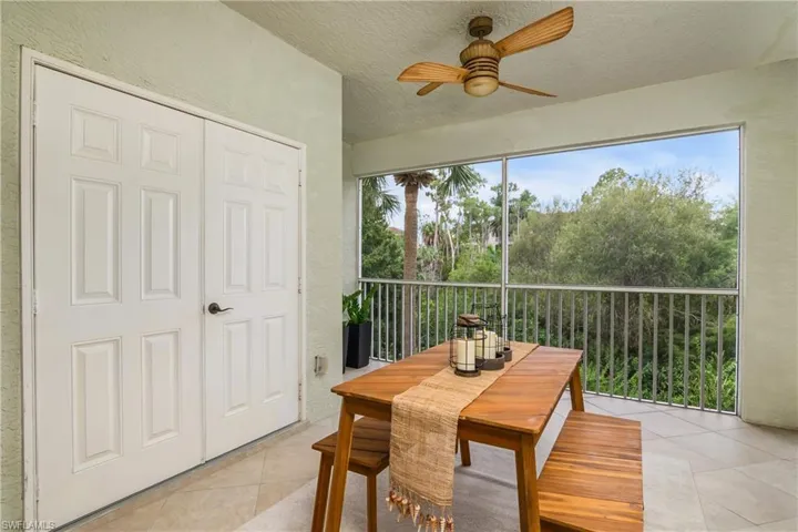 Sunroom with a healthy amount of sunlight and ceiling fan