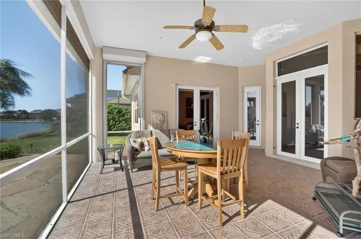 Sunroom / solarium with ceiling fan and french doors