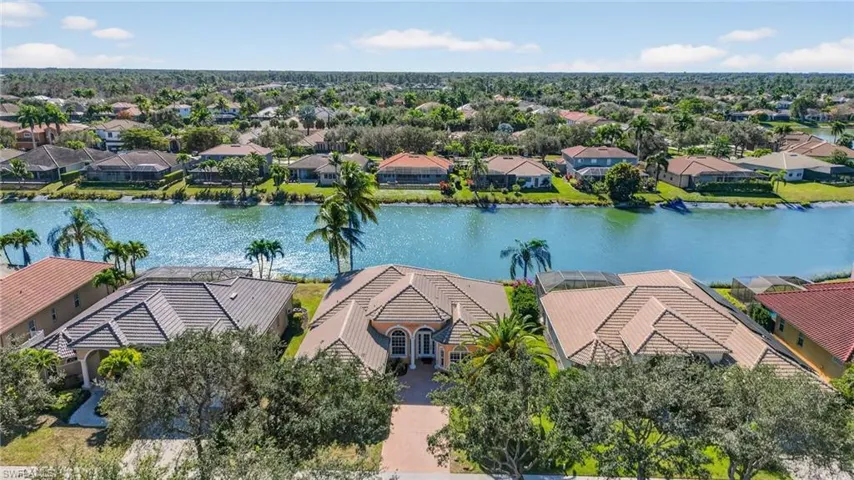 Aerial view of residential area featuring a large body of water