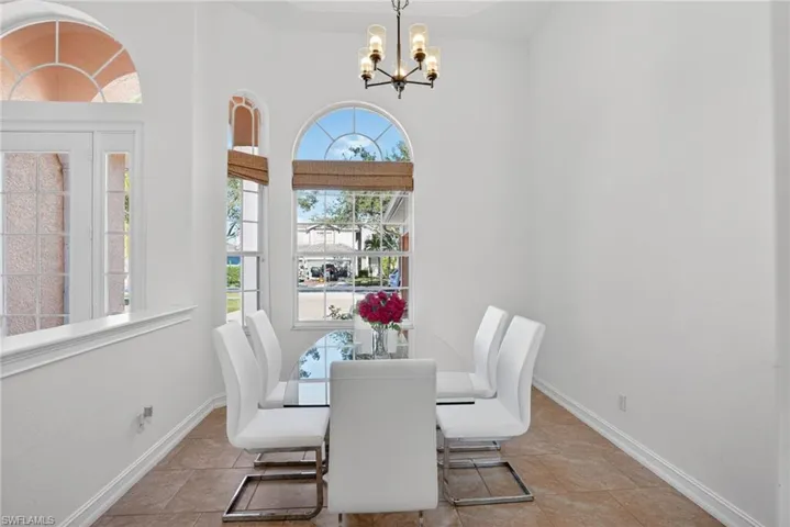 Dining space featuring a chandelier and tile patterned flooring