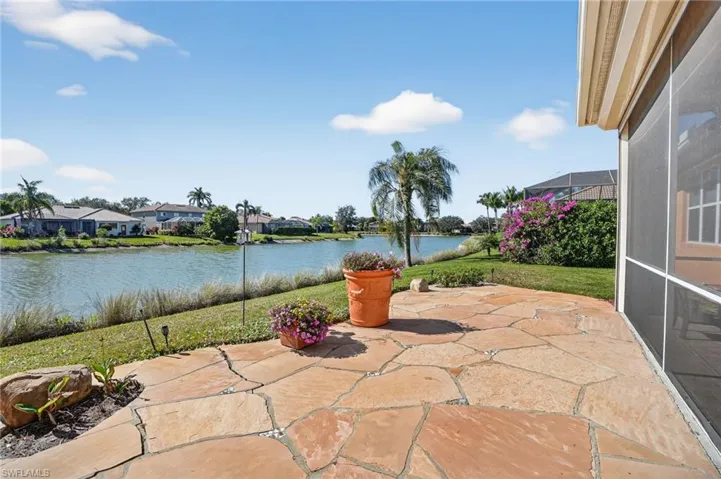 View of patio / terrace with a water view, a sunroom, a residential view, and a lanai