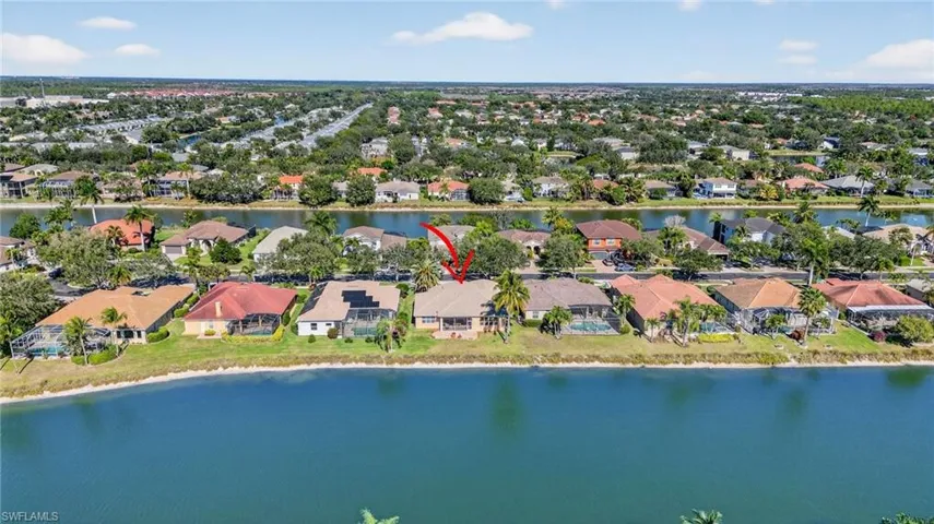 Aerial perspective of suburban area featuring a large body of water