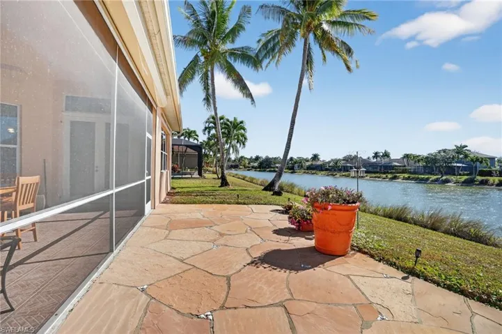 View of patio / terrace with a lanai, a water view, and a sunroom