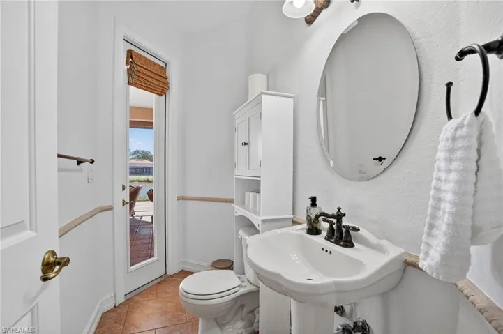 Bathroom featuring toilet and light tile patterned floors