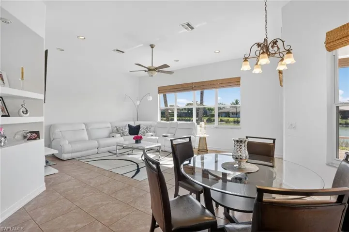 Dining area featuring a ceiling fan, light tile patterned flooring, a chandelier, and recessed lighting