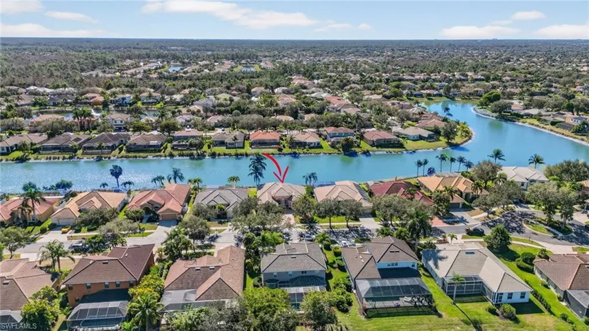 Aerial view of residential area featuring a nearby body of water
