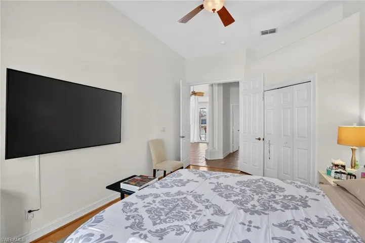 Bedroom featuring a ceiling fan, a closet, and light wood-type flooring
