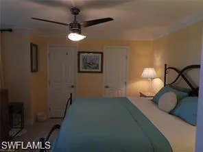 Bedroom with crown molding and ceiling fan