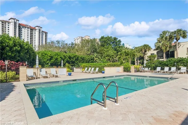Pool with a patio and fence
