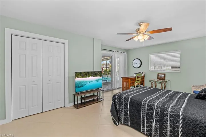 Bedroom with baseboards, ceiling fan, access to outside, a closet, and light tile patterned flooring