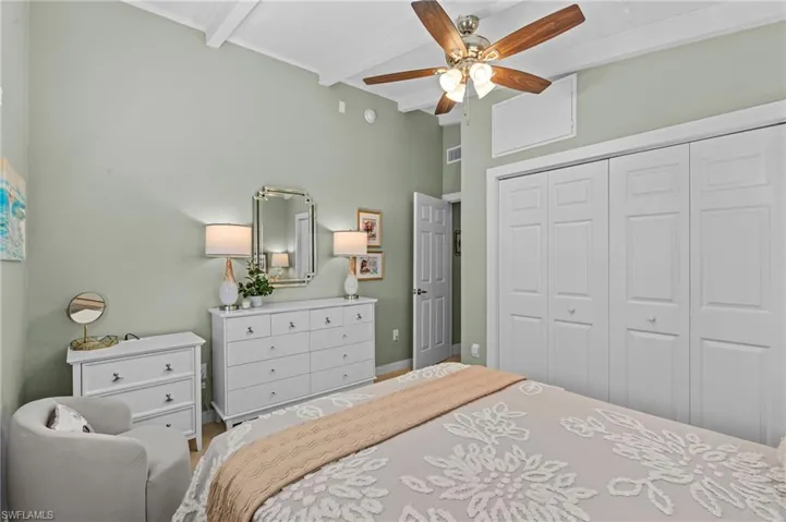 Bedroom featuring lofted ceiling with beams, ceiling fan, a closet, and visible vents
