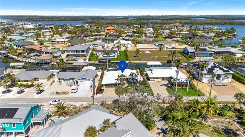 Aerial view featuring a water view and a residential view virtually enhanced image