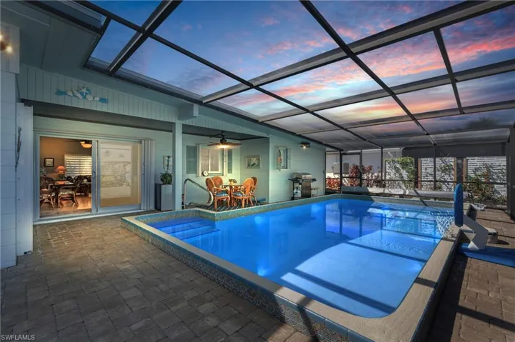 Pool at dusk with a grill and an outdoor pool - VIRTUALLY ENHANCED
