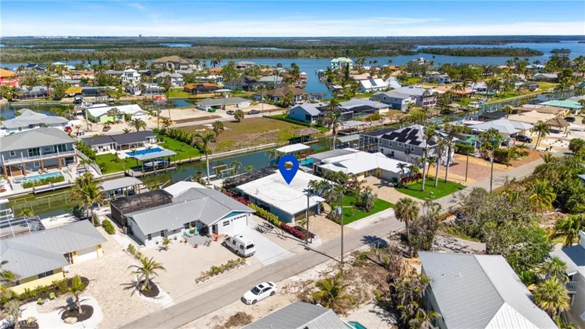 Aerial view with a water view and a residential view virtually enhanced image
