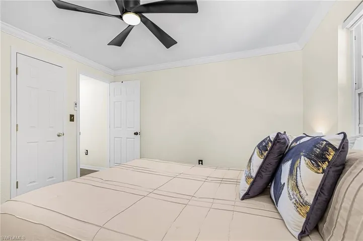 Neutral tone walls with white crown molding and closet door.