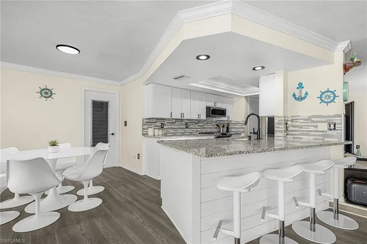 Bar seating and breakfast area flows well with kitchen.