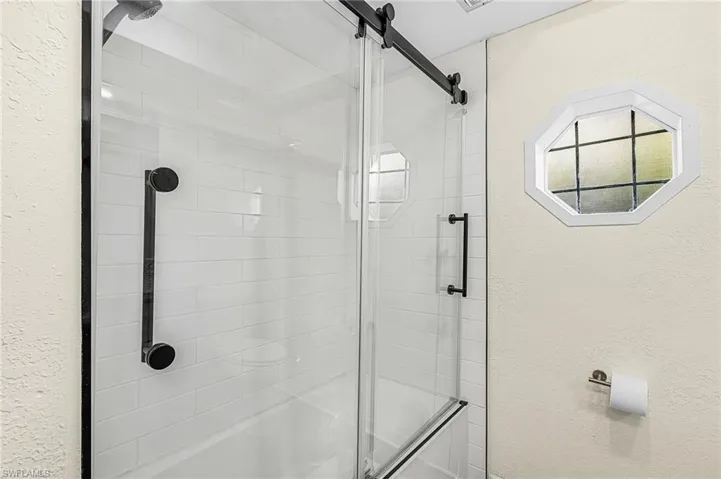 Bathroom with glass slider includes shower/tub combo for the little ones.