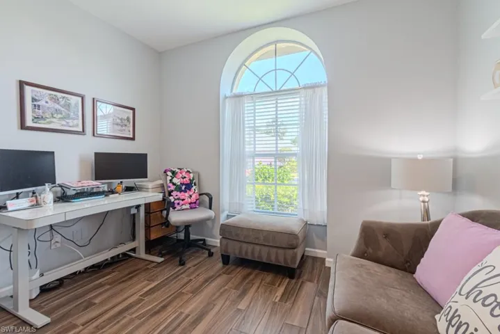Bedroom with dark hardwood / wood-style floors
